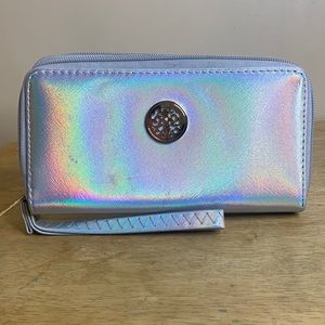 Silver,shinny hand wallet with a strap attached.
